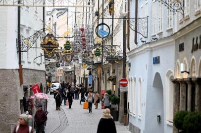 Pedestrians walk along the Getreidegasse in Salzburg, Austria, on November 12, 2021, during the ongoing coronavirus (Covid-19) pandemic. - Austrian Chancellor Schallenberg said on November 12, that he wanted to introduce a nationwide lockdown for those not vaccinated against or recovered from the coronavirus, as cases rapidly rise. The states of Upper Austria and Salzburg, which have seen some of the worse case rates, are already introducing the lockdown for the unvaccinated as of Monday, November 15. (Photo by BARBARA GINDL / APA / AFP) / Austria OUT<!-- NICAID(14939345) -->