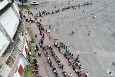 PORTO ALEGRE, RS, BRASIL,  23/11/2021- Centenas de pessoas formam fila para retirada do Cartão Cidadão no Gingantinho. Pessoas chegaram à noite passada para retirada do Cartão Cidadão no Gigantinho. Foto: Lauro Alves  / Agencia RBS<!-- NICAID(14948253) -->