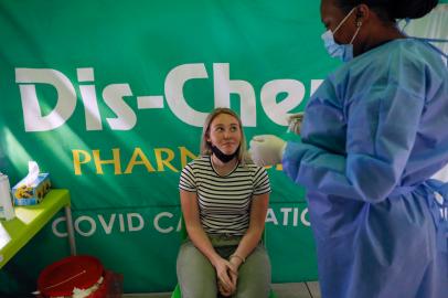 A healthcare worker prepares to conduct a polymerase chain reaction (PCR) Covid-19 test on a traveller  at OR Tambo International Airport in Johannesburg on November 27, 2021, after several countries banned flights from South Africa following the discovery of a new Covid-19 variant Omicron. - A flurry of countries around the world have banned ban flights from southern Africa following the discovery of the variant, including the United States, Canada, Australia,Thailand, Brazil and several European countries. The main countries targeted by the shutdown include South Africa, Botswana, eSwatini (Swaziland), Lesotho, Namibia, Zambia, Mozambique, Malawi and Zimbabwe. (Photo by Phill Magakoe / AFP)<!-- NICAID(14955716) -->