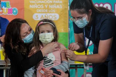 Handout picture released by the Chilean Presidency showing a nurse inoculating a five-year-old girl against the novel coronavirus disease with Chinas Sinopharm vaccine, in Santiago on December 6, 2021. - Minors between the ages of three and five began receiving vaccination against COVID-19 in Chile as the country advances in inoculating adults with the third dose or booster dose. (Photo by Marcelo SEGURA / Chilean Presidency / AFP) / RESTRICTED TO EDITORIAL USE - MANDATORY CREDIT AFP PHOTO / CHILEAN PRESIDENCY / MARCELO SEGURA - NO MARKETING - NO ADVERTISING CAMPAIGNS - DISTRIBUTED AS A SERVICE TO CLIENTS<!-- NICAID(14960445) -->