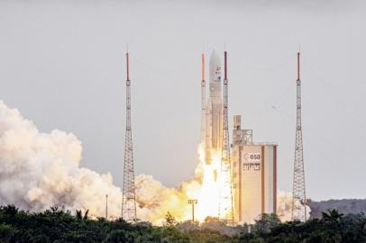 Arianespaces Ariane 5 rocket with NASAs James Webb Space Telescope onboard lifts up from the launchpad, at the Europes Spaceport, the Guiana Space Center in Kourou, French Guiana, on December 25, 2021. - The telescope, the most powerful space observatory ever built, is now tentatively set for launch on Christmas Day, after decades of waiting. An engineering marvel, it will help answer fundamental questions about the Universe, peering back in time 13 billion years. (Photo by jody amiet / AFP)<!-- NICAID(14976550) -->