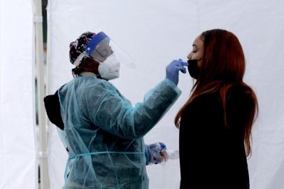 WASHINGTON, DC - DECEMBER 28: A healthcare worker administers a COVID-19 PCR test at a free test site in Farragut Square on December 28, 2021 in Washington, DC. Yesterday the CDC announced that people should self-isolate for five days, instead of ten, after theyve tested positive for Covid-19 if they dont have symptoms.   Anna Moneymaker/Getty Images/AFP (Photo by Anna Moneymaker / GETTY IMAGES NORTH AMERICA / Getty Images via AFP)<!-- NICAID(14978638) -->