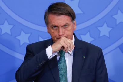 Brazilian President Jair Bolsonaro gestures during the launching of a national program to provide voluntary civil service at the Planalto Palace in Brasilia, on January 28, 2022. (Photo by Sergio Lima / AFP)<!-- NICAID(15003220) -->