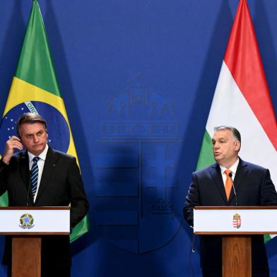 Hungarys Prime Minister Viktor Orban (R) and Brazils President Jair Bolsonaro give a joint press conference on February 17, 2022 in Budapest, Hungary. (Photo by Attila KISBENEDEK / AFP)<!-- NICAID(15018853) -->