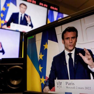 A picture of monitors taken in a media control room in Paris on March 2, 2022, shows French President Emmanuel Macron speaking from the Elysee Palace during a televised address on the general situation seven days after Russia launched a military invasion on Ukraine. (Photo by Ludovic MARIN / AFP)<!-- NICAID(15031646) -->