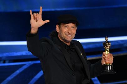 US actor Troy Kotsur accepts the award for Best Actor in a Supporting Role for CODA onstage during the 94th Oscars at the Dolby Theatre in Hollywood, California on March 27, 2022. (Photo by Robyn Beck / AFP)<!-- NICAID(15052735) -->