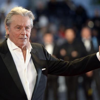 (FILES) This file photo taken on May 25, 2013 shows French actor Alain Delon arriving to attend the screening of the new restored version of the film Plein Soleil presented in Cannes Classics at the 66th edition of the Cannes Film Festival in Cannes.=Delon, the French star dubbed one of the best looking actors of all time, declared on May 9, 2017 that he was calling time on his career. The 81-year-old screen legend -- who is credited with inventing the character of the cerebral hitman, which has since become a Hollywood standard -- told AFP that he would do one last film and a play before retiring. / AFP PHOTO / ANNE-CHRISTINE POUJOULAT<!-- NICAID(12902989) -->