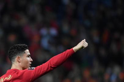 Portugals forward Cristiano Ronaldo (L) waves to supporters at the end of the World Cup 2022 qualifying final first leg football match between Portugal and North Macedonia at the Dragao stadium in Porto on March 29, 2022. -  (Photo by MIGUEL RIOPA / AFP)<!-- NICAID(15064762) -->