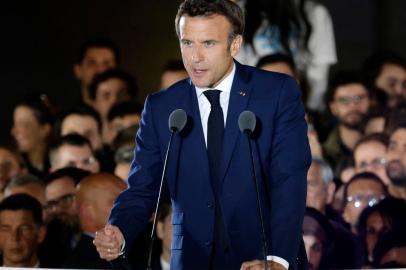 French President and La Republique en Marche (LREM) party candidate for re-election Emmanuel Macron gestures as he delivers a speech after his victory in Frances presidential election, at the Champ de Mars in Paris, on April 24, 2022. (Photo by Ludovic MARIN / AFP)<!-- NICAID(15076912) -->