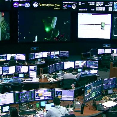 In this screengrab from a NASA TV broadcast the SpaceX control room technicians in Hawthorne, California, watch as the crew of the AX-1 mission undocked from the International Space Station on April 24, 2022. - The crew of the first fully private mission to the International Space Station departed the orbiting laboratory on Monday to head back to Earth.The three businessmen and a former NASA astronaut had spent more than two weeks on the station on a history-making mission organized by startup company Axiom Space. (Photo by Handout / NASA TV / AFP) / RESTRICTED TO EDITORIAL USE - MANDATORY CREDIT AFP PHOTO / NASA TV - NO MARKETING - NO ADVERTISING CAMPAIGNS - DISTRIBUTED AS A SERVICE TO CLIENTS<!-- NICAID(15077445) -->