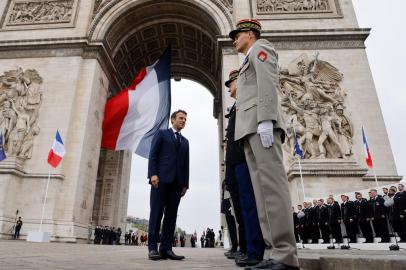 Emmanuel Macron (L) speaks to military officers at the Arc de Triomphe as part of the ceremonies marking the Allied victory against Nazi Germany and the end of World War II in Europe (VE Day), in Paris on May 8, 2022. (Photo by Ludovic MARIN / various sources / AFP)<!-- NICAID(15090331) -->