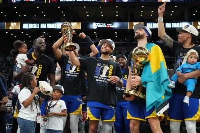 BOSTON, MA - JUNE 16: Stephen Curry #30 of the Golden State Warriors celebrates on stage with the Bill Russell Finals MVP Trophy after winning during Game Six of the 2022 NBA Finals on June 16, 2022 at TD Garden in Boston, Massachusetts. NOTE TO USER: User expressly acknowledges and agrees that, by downloading and or using this photograph, user is consenting to the terms and conditions of Getty Images License Agreement. Mandatory Copyright Notice: Copyright 2022 NBAE   Jesse D. Garrabrant/NBAE via Getty Images/AFP (Photo by Jesse D. Garrabrant / NBAE / Getty Images / Getty Images via AFP)<!-- NICAID(15126611) -->