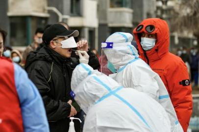 This photo taken on March 14, 2022 shows a resident underging a nucleic acid test for the Covid-19 coronavirus in Shenyang, in Chinas northeastern Liaoning province. (Photo by AFP) / China OUT<!-- NICAID(15047409) -->