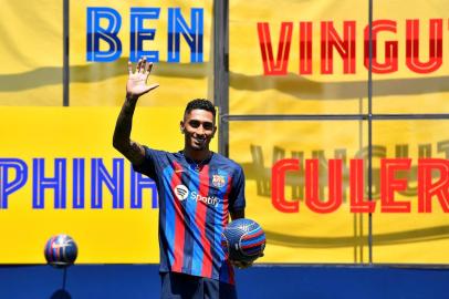 FC Barcelonas new Brazilian forward Raphael Dias Belloli, aka Raphinha, poses for pictures during his presentation ceremony at the Joan Gamper training ground in Sant Joan Despi, near Barcelona, on July 15, 2022. (Photo by Pau BARRENA / AFP)<!-- NICAID(15149752) -->