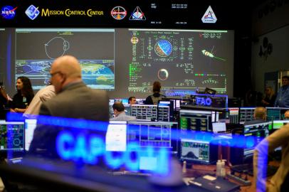 People walk through the White Flight Control Room at the Johnson Space Centers Mission Control Center in Houston, Texas, on August 5, 2022. - Rick LaBrode has worked at NASA for 37 years, but he says the American quest to return to the Moon is by far the crowning moment of his career. LaBrode is the lead flight director for Artemis 1, set to take off later this month -- the first time a capsule that can carry humans will be sent to the Moon since the last Apollo mission in 1972. (Photo by Mark Felix / AFP)<!-- NICAID(15175758) -->