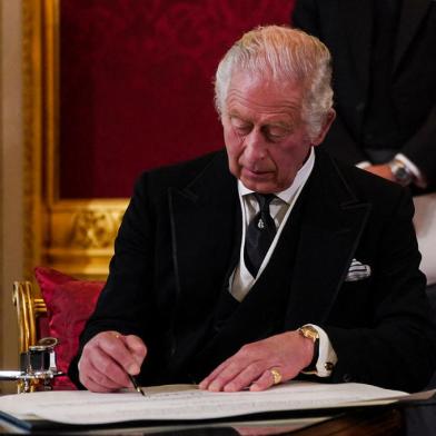 Britains King Charles III signs an oath to uphold the security of the Church in Scotland, during a meeting of the Accession Council inside St Jamess Palace in London on September 10, 2022, to proclaim him as the new King. - Britains Charles III was officially proclaimed King in a ceremony on Saturday, a day after he vowed in his first speech to mourning subjects that he would emulate his darling mama, Queen Elizabeth II who died on September 8. (Photo by Victoria Jones / POOL / AFP)<!-- NICAID(15202739) -->