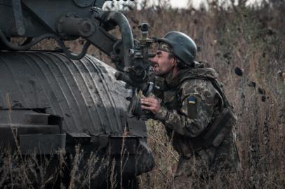 A Ukrainian soldier prepares to fire a BM-21 Grad multiple rocket launcher towards Russian positions in Kharkiv region on October 4, 2022. (Photo by Yasuyoshi CHIBA / AFP)<!-- NICAID(15226412) -->