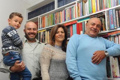 CAXIAS DO SUL, RS, BRASIL, 12/10/2022. No Dia do Professor, a reportagem conta histórias de pais que passaram o amor pela profissão aos filhos, que seguiram o mesmo caminho. Na família de Olga Neri de Campos Lima, 57 aconteceu o mesmo: o primogênito escolheu a mesma profissão dos pais. Professora de Língua Portuguesa, Olga é casada com o também professor Austinho Antunes Lima Filho, 58, e mãe de Augusto, 36, e Rodolfo, 29. Na foto, Olga, Austinho, o filho Augusto e o neto Otávio Bangel Lima. (Bruno Todeschini/Agência RBS)<!-- NICAID(15233808) -->