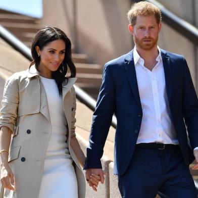 (FILES) In this file photo taken on October 16, 2018 Britains Prince Harry and his wife Meghan walk down the stairs of Sydneys iconic Opera House to meet people in Sydney. - After a week of digs at Britains royal family, just how far will Prince Harry and Meghan Markle go in their hotly anticipated interview with Oprah Winfrey? Millions of people will tune in to CBS the evening of March 7, 2021 to find out, and if that trickle of excerpts is any indication, they have scores to settle with Buckingham Palace a bit over a year after giving up frontline duties as royals and moving to southern California. (Photo by SAEED KHAN / AFP)<!-- NICAID(14736937) -->