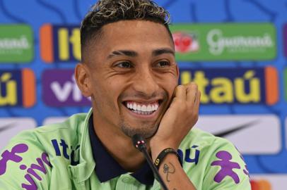 Brazils forward Raphinha smiles as he gives a press conference at the Al Arabi SC in Doha on November 21, 2022, during of the Qatar 2022 World Cup football tournament. (Photo by NELSON ALMEIDA / AFP)<!-- NICAID(15271825) -->