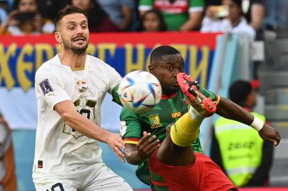 Cameroons defender #19 Collins Fai fights for the ball with Serbias forward #10 Dusan Tadic during the Qatar 2022 World Cup Group G football match between Cameroon and Serbia at the Al-Janoub Stadium in Al-Wakrah, south of Doha on November 28, 2022. (Photo by Issouf SANOGO / AFP)Editoria: SPOLocal: DohaIndexador: ISSOUF SANOGOSecao: soccerFonte: AFPFotógrafo: STF<!-- NICAID(15278497) -->