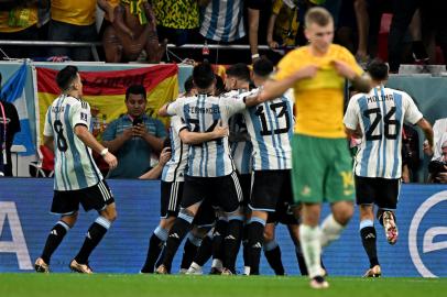 Argentinas forward #10 Lionel Messi (covered) celebrates with teammates after scoring his teams first goal during the Qatar 2022 World Cup round of 16 football match between Argentina and Australia at the Ahmad Bin Ali Stadium in Al-Rayyan, west of Doha on December 3, 2022. (Photo by MANAN VATSYAYANA / AFP)Editoria: SPOLocal: DohaIndexador: MANAN VATSYAYANASecao: soccerFonte: AFPFotógrafo: STF<!-- NICAID(15284886) -->