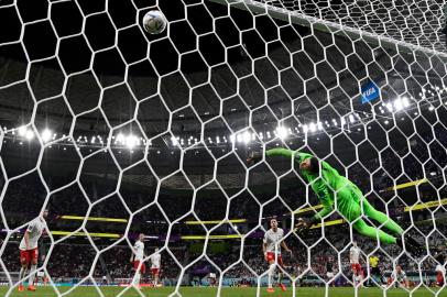 Polands goalkeeper #01 Wojciech Szczesny concedes a goal by Frances forward #10 Kylian Mbappe (R) during the Qatar 2022 World Cup round of 16 football match between France and Poland at the Al-Thumama Stadium in Doha on December 4, 2022. (Photo by Glyn KIRK / AFP)<!-- NICAID(15285287) -->