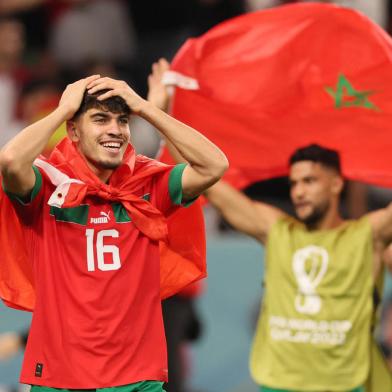 Moroccos forward #16 Abde Ezzalzouli (L) celebrates after winning the Qatar 2022 World Cup round of 16 football match between Morocco and Spain at the Education City Stadium in Al-Rayyan, west of Doha on December 6, 2022. (Photo by KARIM JAAFAR / AFP)<!-- NICAID(15287314) -->