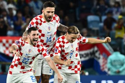 (FromL) Croatias defender #22 Josip Juranovic, Croatias forward #14 Marko Livaja and Croatias midfielder #07 Lovro Majer celebrate winning after penalty shoot-out the Qatar 2022 World Cup round of 16 football match between Japan and Croatia at the Al-Janoub Stadium in Al-Wakrah, south of Doha on December 5, 2022. (Photo by Jewel SAMAD / AFP)<!-- NICAID(15288535) -->