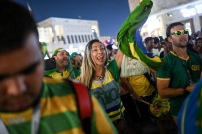 Brazils supporters celebrate and wave Brazilian flags at the Souq Waqif marketplace in Doha on November 30, 2022, during the Qatar 2022 World Cup football tournament. (Photo by OZAN KOSE / AFP)<!-- NICAID(15289986) -->