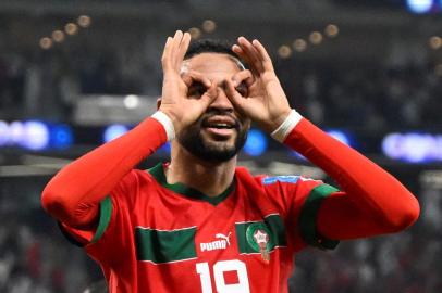 Moroccos forward #19 Youssef En-Nesyri celebrates after scoring the opening goal during the Qatar 2022 World Cup quarter-final football match between Morocco and Portugal at the Al-Thumama Stadium in Doha on December 10, 2022. (Photo by PATRICIA DE MELO MOREIRA / AFP)<!-- NICAID(15292096) -->