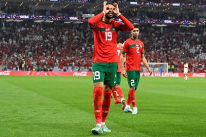 Moroccos forward #19 Youssef En-Nesyri celebrates after scoring the opening goal during the Qatar 2022 World Cup quarter-final football match between Morocco and Portugal at the Al-Thumama Stadium in Doha on December 10, 2022. (Photo by PATRICIA DE MELO MOREIRA / AFP)<!-- NICAID(15292097) -->