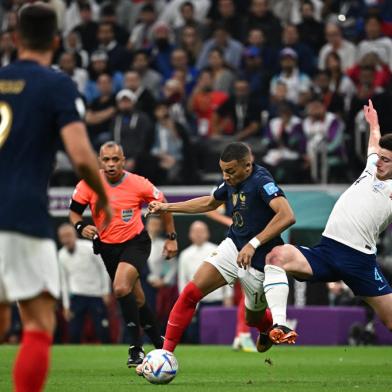 Frances forward #10 Kylian Mbappe (C) is challenged by Englands midfielder #04 Declan Rice during the Qatar 2022 World Cup quarter-final football match between England and France at the Al-Bayt Stadium in Al Khor, north of Doha, on December 10, 2022. (Photo by Anne-Christine POUJOULAT / AFP)Editoria: SPOLocal: Al KhorIndexador: ANNE-CHRISTINE POUJOULATSecao: soccerFonte: AFPFotógrafo: STF<!-- NICAID(15292143) -->