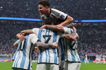 Argentinas forward #10 Lionel Messi (L) celebrates with teammates after he scored his teams first goal from the penalty spot during the Qatar 2022 World Cup football semi-final match between Argentina and Croatia at Lusail Stadium in Lusail, north of Doha on December 13, 2022. (Photo by JACK GUEZ / AFP)<!-- NICAID(15294329) -->