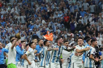 Argentina players celebrate with their supporters after they won the Qatar 2022 World Cup football semi-final match between Argentina and Croatia at Lusail Stadium in Lusail, north of Doha on December 13, 2022. (Photo by Giuseppe CACACE / AFP)<!-- NICAID(15294550) -->