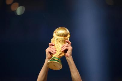 A player of Argentina lifts the World Cup trophy during the Qatar 2022 World Cup trophy ceremony after the football final match between Argentina and France at Lusail Stadium in Lusail, north of Doha on December 18, 2022. - Argentina won in the penalty shoot-out. (Photo by FRANCK FIFE / AFP)<!-- NICAID(15303430) -->