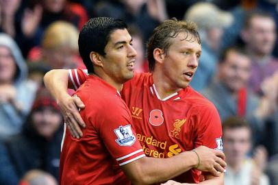 170611348Liverpools Uruguayan striker Luis Suarez (L) celebrates scoring his teams third goal with Liverpools Brazilian midfielder Lucas Leiva during the English Premier League football match between Liverpool and Fulham at Anfield in Liverpool, northwest England on November 9, 2013. AFP PHOTO/PAUL ELLISRESTRICTED TO EDITORIAL USE. No use with unauthorized audio, video, data, fixture lists, club/league logos or live services. Online in-match use limited to 45 images, no video emulation. No use in betting, games or single club/league/player publications. (Photo by PAUL ELLIS / AFP)Editoria: SPOLocal: LiverpoolIndexador: PAUL ELLISSecao: soccerFonte: AFP<!-- NICAID(15304878) -->