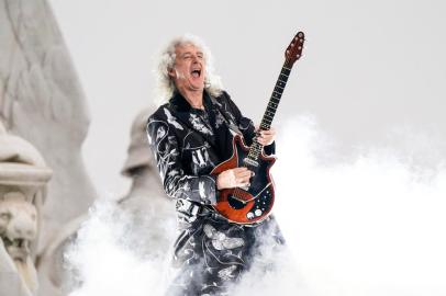 (FILES) In this file photo taken on June 4, 2022 British guitarist Brian May of Queen performs during the Platinum Party at Buckingham Palace as part of Queen Elizabeth IIs platinum jubilee celebrations. - Brian May, guitarist of the rock band Queen, is one of 1,107 people who have been awarded this year in a list signed for the first time by King Charles III. These royal awards are given twice a year, on New Years Day and on the Kings official birthday, always celebrated in June, regardless of the monarchs actual date of birth (14 November 1948 for Charles III). (Photo by Alberto Pezzali / POOL / AFP)<!-- NICAID(15309989) -->