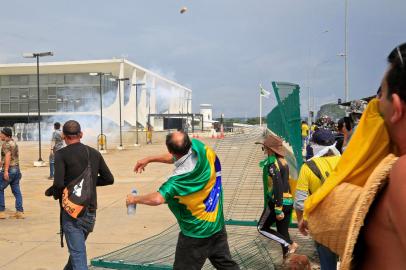 Supporters of Brazilian former President Jair Bolsonaro clash with riot police at Planalto Presidential Palace in Brasilia on January 8, 2023. - Hundreds of supporters of Brazils far-right ex-president Jair Bolsonaro broke through police barricades and stormed into Congress, the presidential palace and the Supreme Court Sunday, in a dramatic protest against President Luiz Inacio Lula da Silvas inauguration last week. (Photo by Sergio Lima / AFP)Editoria: WARLocal: BrasíliaIndexador: SERGIO LIMASecao: demonstrationFonte: AFPFotógrafo: STR<!-- NICAID(15315545) -->