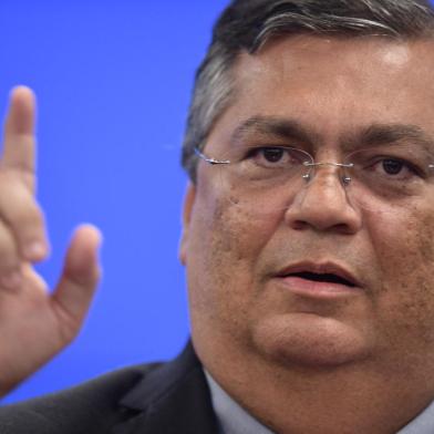 Brazilian Justice and Public Security Minister Flavio Dino gestures during a press conferente at the Justice Palace in Brasilia on January 9, 2023, a day after supporters of Brazils far-right ex-president Jair Bolsonaro invaded the Congress, presidential palace and Supreme Court. - Brazilian security forces locked down the area around Congress, the presidential palace and the Supreme Court Monday, a day after supporters of ex-president Jair Bolsonaro stormed the seat of power in riots that triggered an international outcry. Hardline Bolsonaro supporters have been protesting outside army bases calling for a military intervention to stop Lula from taking power since his election win. (Photo by CARL DE SOUZA / AFP)Editoria: POLLocal: BrasíliaIndexador: CARL DE SOUZASecao: politics (general)Fonte: AFPFotógrafo: STF<!-- NICAID(15316250) -->