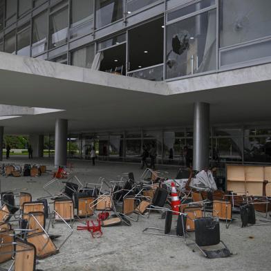 Partial view of one of entrance of Planalto Presidential Palace destroyed by supporters of Brazilian former President Jair Bolsonaro during an invasion, in Brasilia on January 9, 2023. - Brazilian security forces locked down the area around Congress, the presidential palace and the Supreme Court Monday, a day after supporters of ex-president Jair Bolsonaro stormed the seat of power in riots that triggered an international outcry.In stunning scenes reminiscent of the January 6, 2021 invasion of the US Capitol building by supporters of then-president Donald Trump, backers of Bolsonaro broke through police cordons and overran the seats of power in Brasilia, smashing windows and doors and ransacking offices. (Photo by CARL DE SOUZA / AFP)<!-- NICAID(15316473) -->