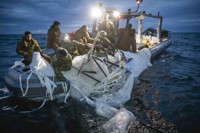 This picture provided by the US Navy shows sailors assigned to Explosive Ordnance Disposal Group 2 recover a high-altitude surveillance balloon off the coast of Myrtle Beach, South Carolina, in the Atlantic ocean on February 5, 2023. - US President Joe Biden on February 6, 2023 defended the decision to wait until a Chinese balloon crossed the United States before shooting it down, and the White House said valuable intelligence was being culled from the device. (Photo by Petty Officer 1st Class Tyler Thompson / US NAVY / AFP) / RESTRICTED TO EDITORIAL USE - MANDATORY CREDIT AFP PHOTO /  US NAVY - NO MARKETING NO ADVERTISING CAMPAIGNS - DISTRIBUTED AS A SERVICE TO CLIENTS / The erroneous mention[s] appearing in the metadata of this photo has been modified in AFP systems in the following manner: corrects photographers byline in metadata field [Petty Officer 1st Class Tyler Thompson] instead of [Petty Officer 1st Class Tyler Th]. Please immediately remove the erroneous mention[s] from all your online services and delete it (them) from your servers. If you have been authorized by AFP to distribute it (them) to third parties, please ensure that the same actions are carried out by them. Failure to promptly comply with these instructions will entail liability on your part for any continued or post notification usage. Therefore we thank you very much for all your attention and prompt action. We are sorry for the inconvenience this notification may cause and remain at your disposal for any further information you may require.<!-- NICAID(15344230) -->